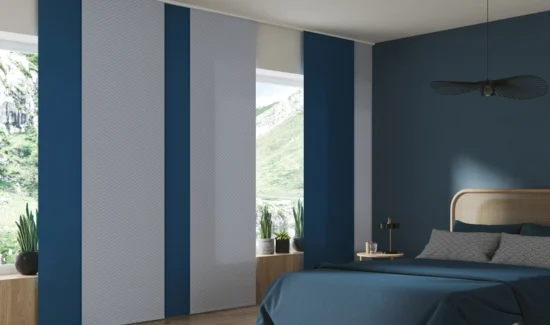 Ein minimalistisches Schlafzimmer mit Blautönen und passenden Flächenvorhängen abwechselnd in blau und grau.