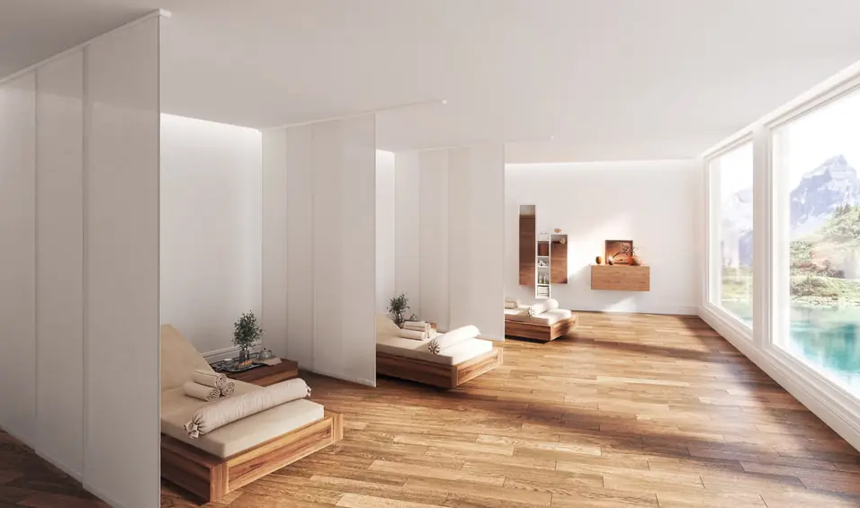 Ein helles Zimmer mit drei Massageliegen, die von weißen Flächenvorhängen abgetrennt werden.